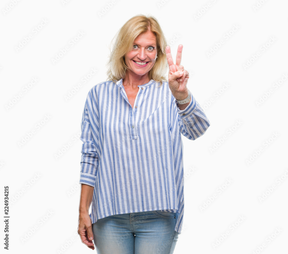 Middle age blonde business woman over isolated background smiling with happy face winking at the camera doing victory sign. Number two. Middle age blonde business woman over isolated background smiling with happy face winking at the camera doing victory sign. Number two.