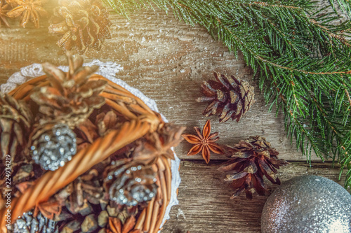 Christmas New Year composition with gift box fir branch basket pine cones on old shabby rustic wooden background. Xmas holiday december decoration to Russian tradition. Flat lay, copy space