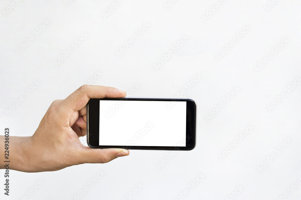 Man hand holding horizontal the black smartphone with blank screen, isolated on white background. Man hand holding horizontal the black smartphone with blank screen, isolated on white background.
