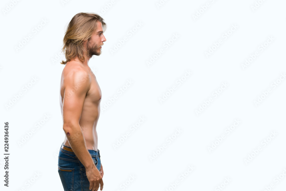 Young handsome shirtless man with long hair showing sexy body over isolated  background looking to side, relax profile pose with natural face with  confident smile. Stock Photo | Adobe Stock