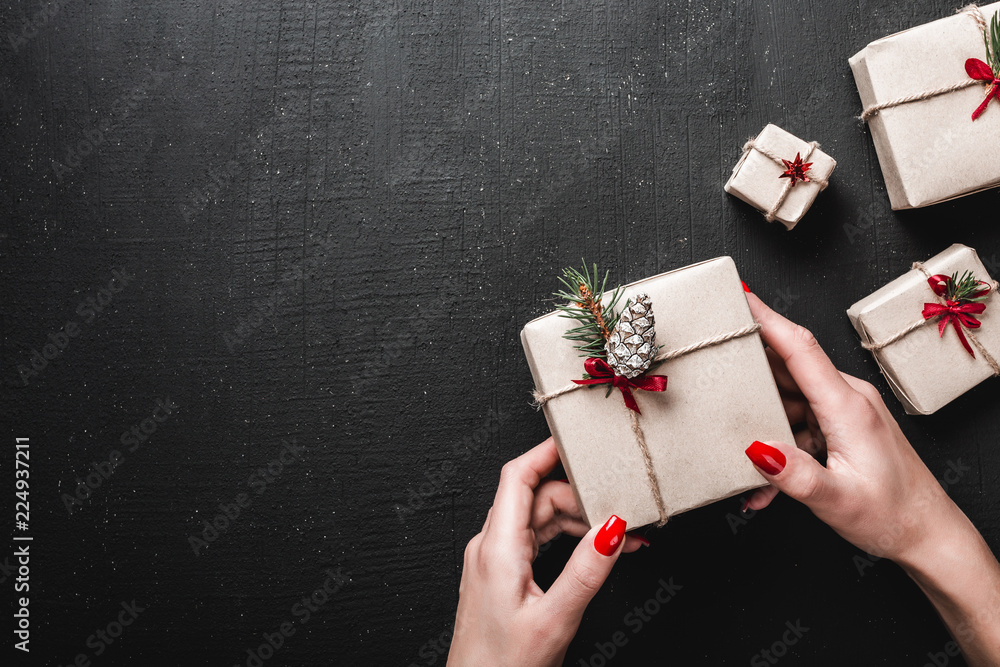 custom made wallpaper toronto digitalOn a black background, a lady holds a gorgeous gift. Handmade gifts and Xmas atmosphere. Space for a greeting message. Top view.