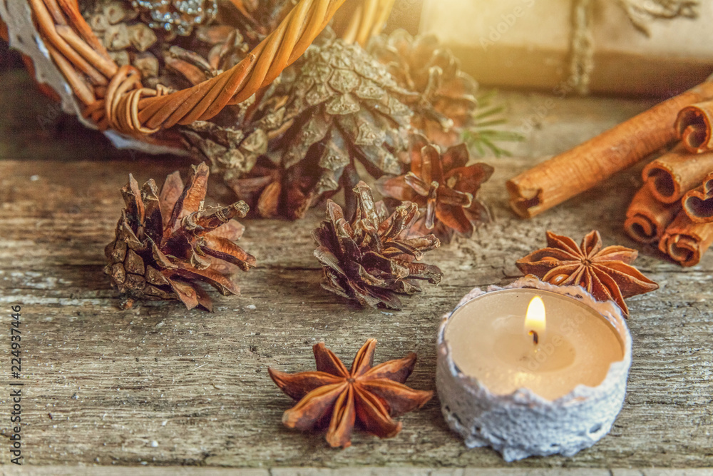 Christmas New Year composition with gift box fir branch basket pine cones candle on old shabby rustic wooden background. Xmas holiday december decoration to Russian tradition. Flat lay, copy space Christmas New Year composition with gift box fir branch basket pine cones candle on old shabby rustic wooden background. Xmas holiday december decoration to Russian tradition. Flat lay, copy space