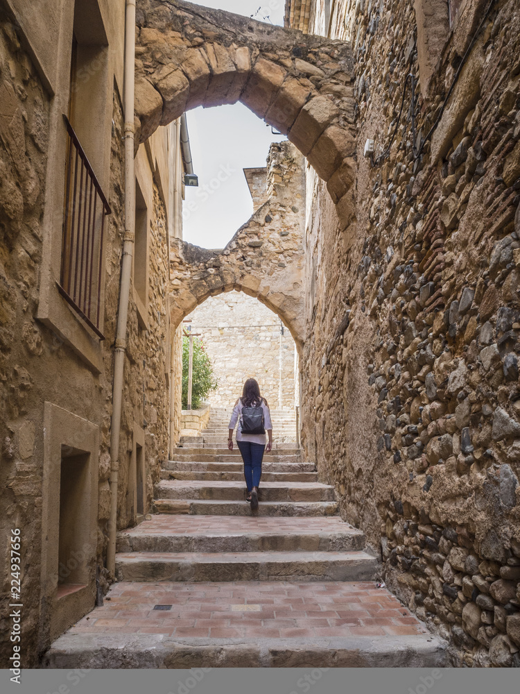 Woman walking in medieval village