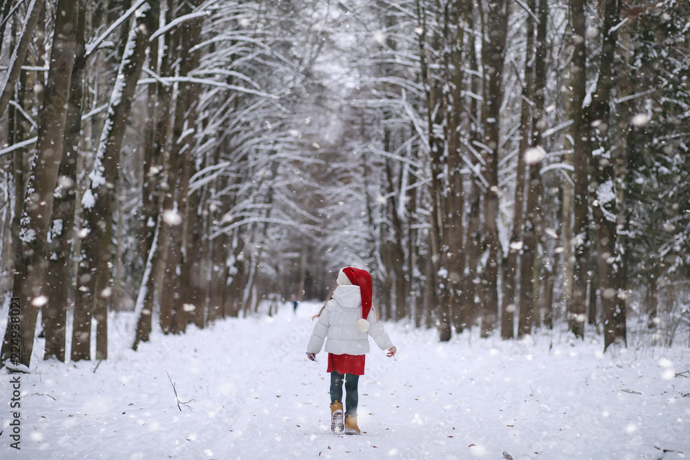 A winter fairy tale, a young mother and her daughter ride a sled