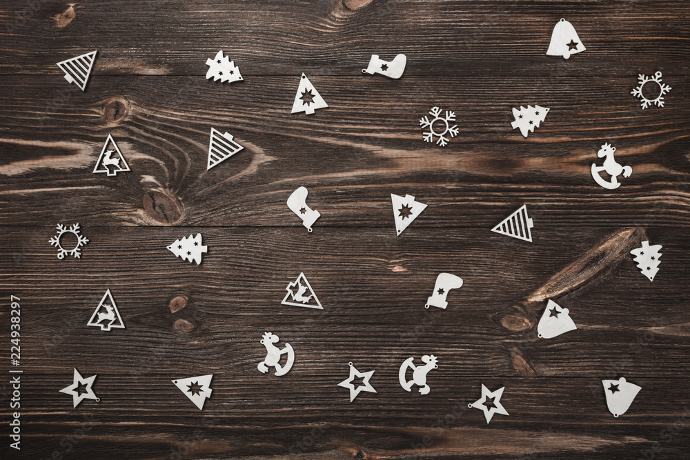 Fototapeta premium View from above of handmade tree toys on wooden background, greeting card