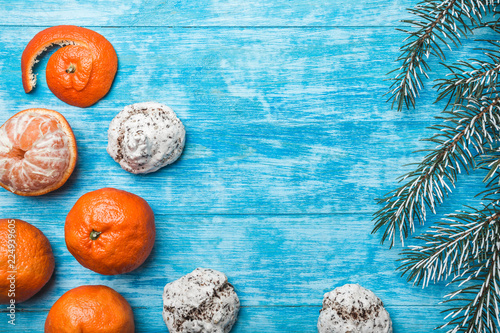 Wallpaper of azure wood, open, sea. mandarins, green fir branch. Xmas and New Year's Message. Sweets for holidays. Xmas and Happy New Year composition. Flat lay, top view