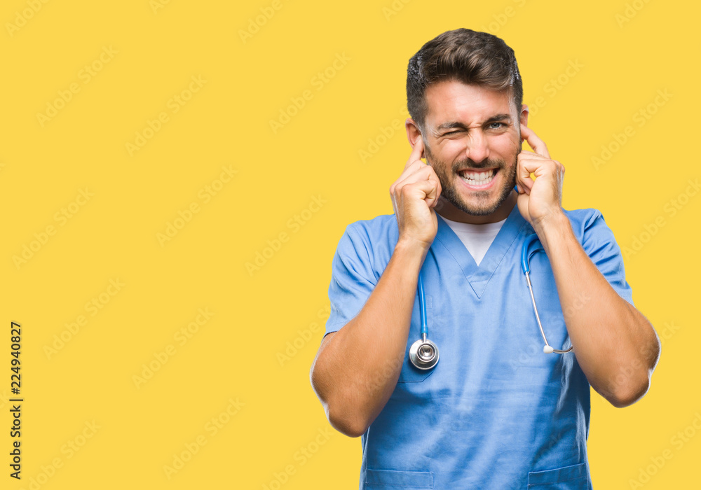 Young handsome doctor surgeon man over isolated background covering ears with fingers with annoyed expression for the noise of loud music. Deaf concept. Young handsome doctor surgeon man over isolated background covering ears with fingers with annoyed expression for the noise of loud music. Deaf concept.