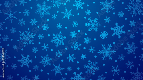 Christmas illustration with various small snowflakes on gradient background in blue colors