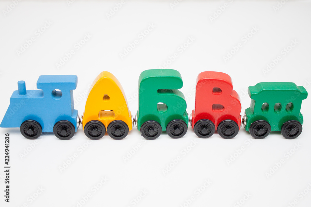 Russian wooden letters train alphabet with locomotive. Bright colors of red yellow green and blue on a white background. Early childhood education, learning to read, preschool and kids game concept.
