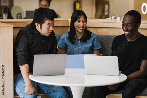 Friends looking at laptop