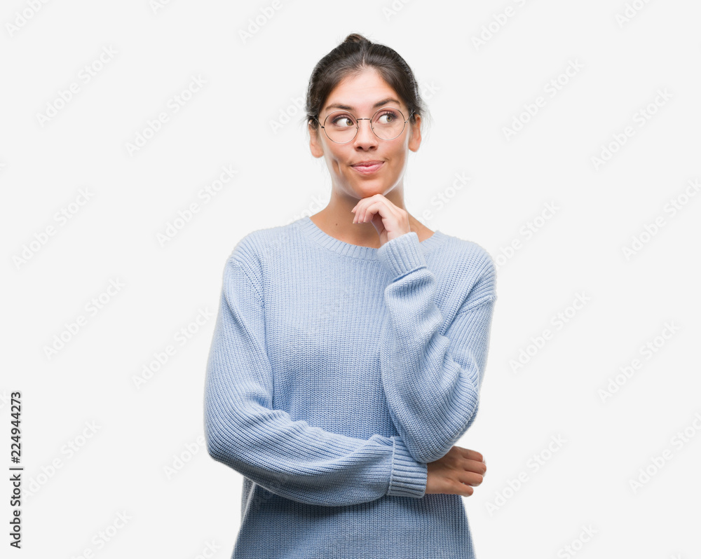 Young beautiful hispanic woman wearing a bun serious face thinking about question, very confused idea Young beautiful hispanic woman wearing a bun serious face thinking about question, very confused idea