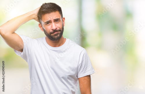 Adult hispanic man over isolated background confuse and wonder about question. Uncertain with doubt, thinking with hand on head. Pensive concept.