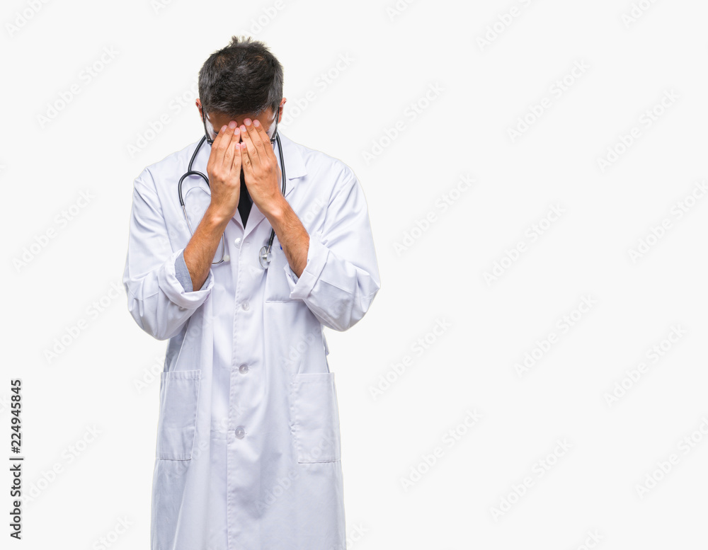 Adult hispanic doctor man over isolated background with sad expression covering face with hands while crying. Depression concept. Adult hispanic doctor man over isolated background with sad expression covering face with hands while crying. Depression concept.