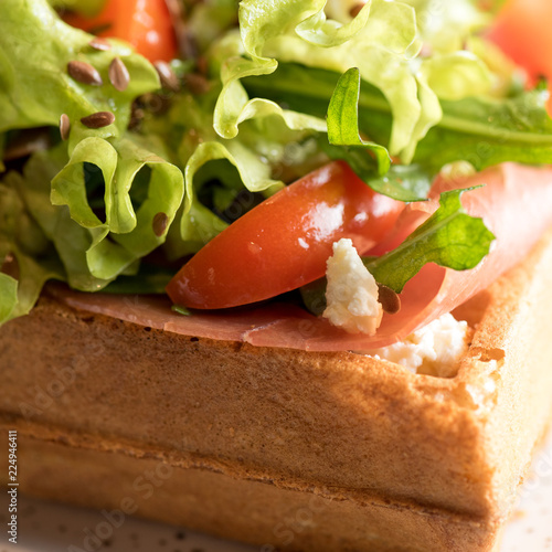 Homemade Belgian Waffle with salad Iceberg, tomatoes and ham photo