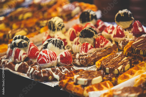 Stroopwafel, stroop wafel, also known as syrup waffle, is one of the famous Dutch snack from The Netherlands, counter with different candy desserts, sweet tasty candy dessert variety in Amsterdam © tsuguliev