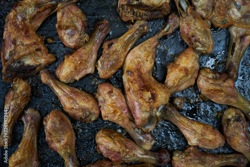 Grilled chicken drumsticks background, top view, close-up. Roasted chicken legs, Cooked with sauce