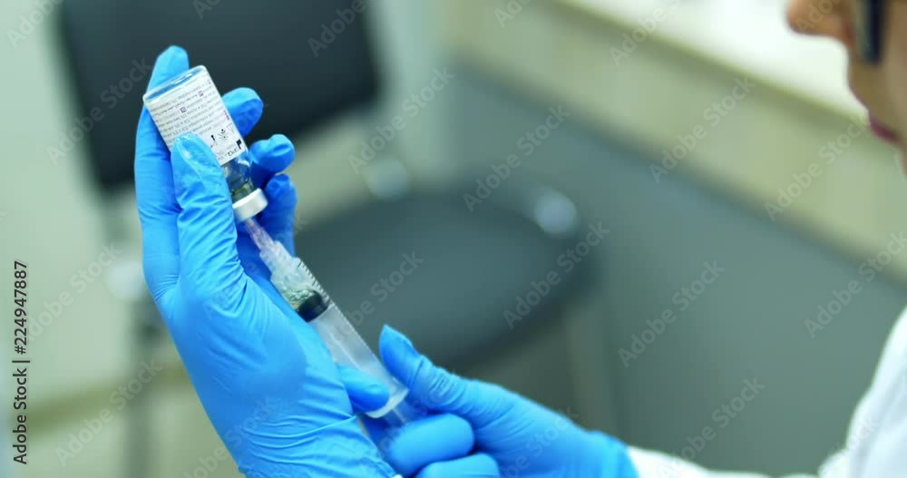 Doctor prepare syringe with a medicine Doctor prepare syringe with a medicine