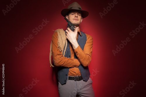 cowboy with a pistol, a gold miner adventure guy in a hat with a gun photo