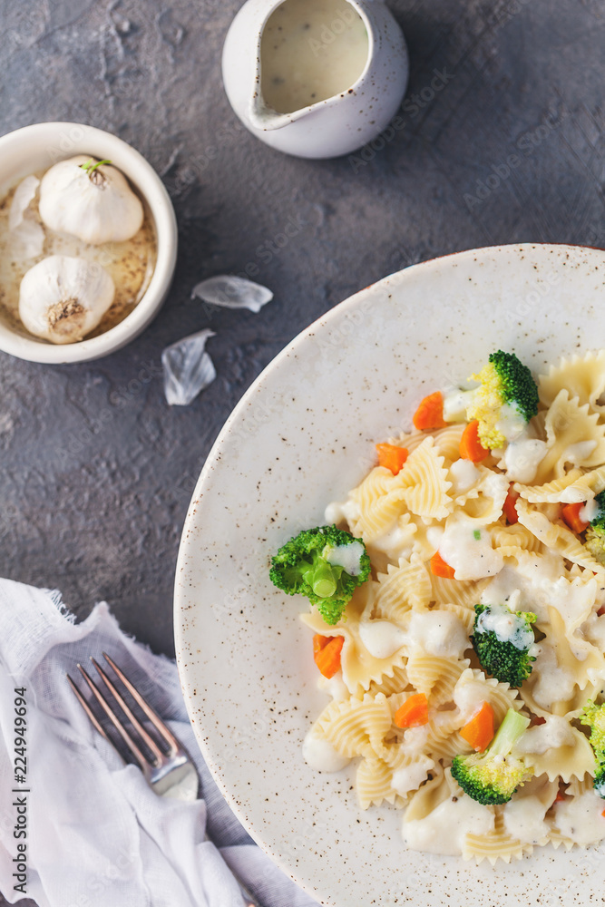 Homemade farfalle with with broccoli and carrots, bechamel Homemade farfalle with with broccoli and carrots, bechamel