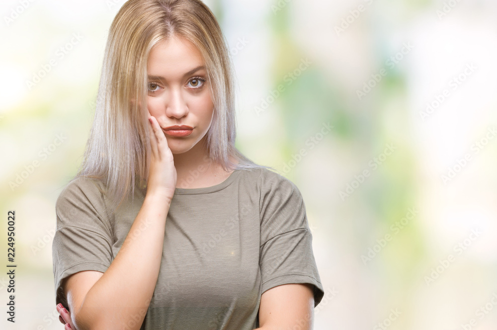 Young blonde woman over isolated background thinking looking tired and bored with depression problems with crossed arms. Young blonde woman over isolated background thinking looking tired and bored with depression problems with crossed arms.