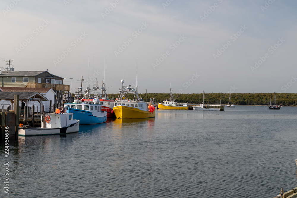 Fototapeta premium fishing boats in autumn sunshine, dockside, eastern passage nova scotia