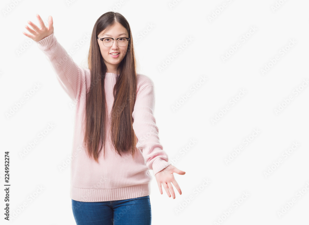 Young Chinese woman over isolated background wearing glasses looking at the camera smiling with open arms for hug. Cheerful expression embracing happiness. Young Chinese woman over isolated background wearing glasses looking at the camera smiling with open arms for hug. Cheerful expression embracing happiness.