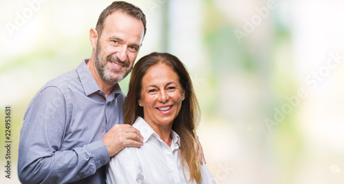 Middle age hispanic business couple over isolated background happy face smiling with crossed arms looking at the camera. Positive person.