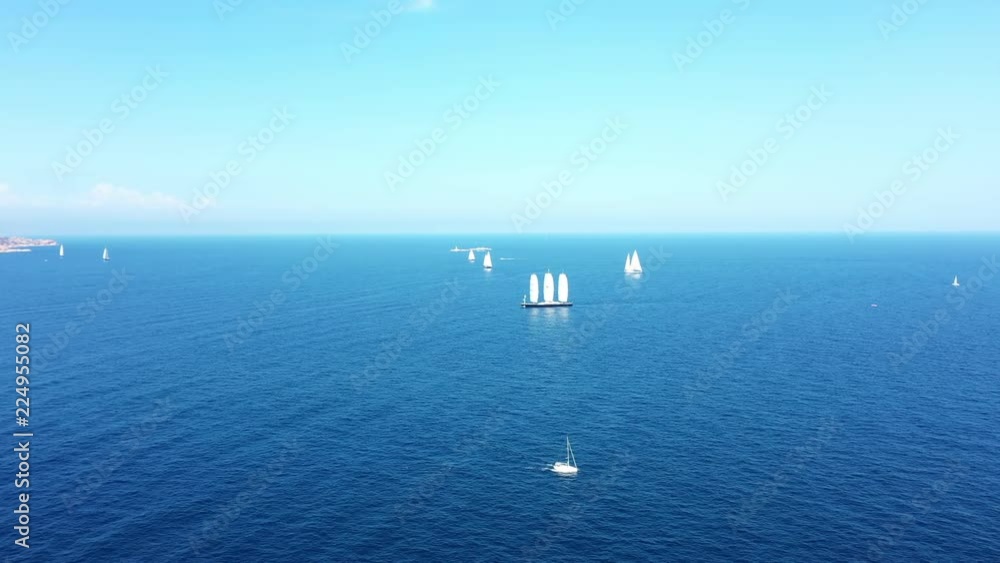 Video from above, aerial view of a beautiful sailing vessel and other yachts during a Regatta. September 2018, Sardinia, Italy. Video from above, aerial view of a beautiful sailing vessel and other yachts during a Regatta. September 2018, Sardinia, Italy.