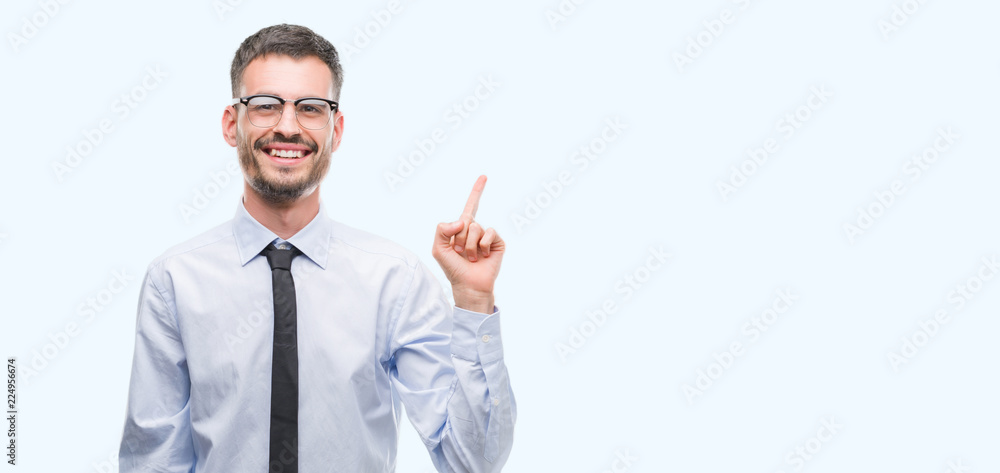 Young business man very happy pointing with hand and finger to the side Young business man very happy pointing with hand and finger to the side