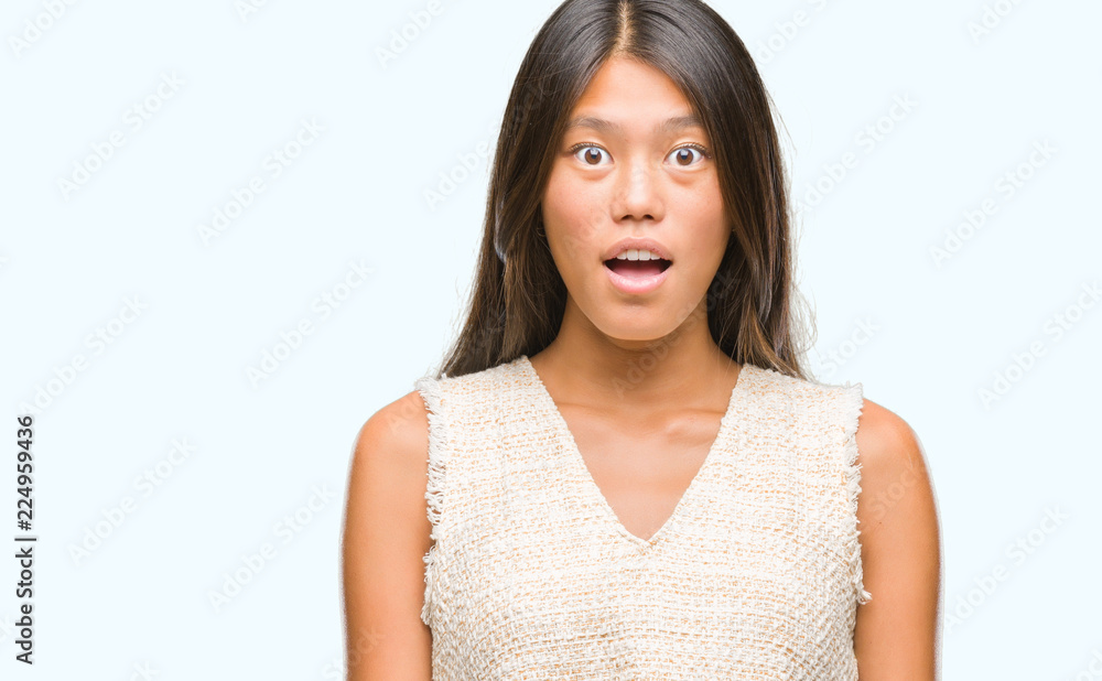 Young asian woman over isolated background afraid and shocked with surprise expression, fear and excited face. Young asian woman over isolated background afraid and shocked with surprise expression, fear and excited face.