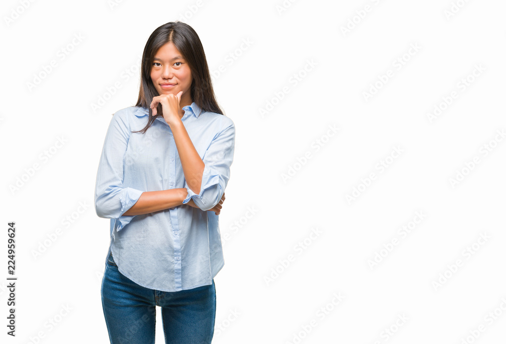 Young asian business woman over isolated background looking confident at the camera with smile with crossed arms and hand raised on chin. Thinking positive. Young asian business woman over isolated background looking confident at the camera with smile with crossed arms and hand raised on chin. Thinking positive.