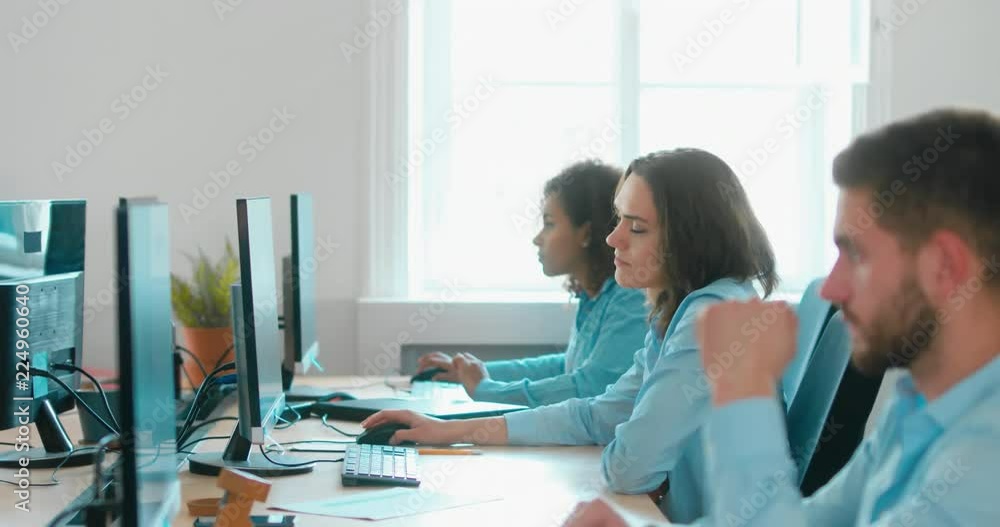 Stressful mid 30s Caucasian female working in busy office. 4K UHD 60 FPS SLOW MOTION Stressful mid 30s Caucasian female working in busy office. 4K UHD 60 FPS SLOW MOTION