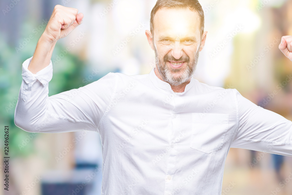 Middle age hoary senior man over isolated background showing arms muscles smiling proud. Fitness concept. Middle age hoary senior man over isolated background showing arms muscles smiling proud. Fitness concept.