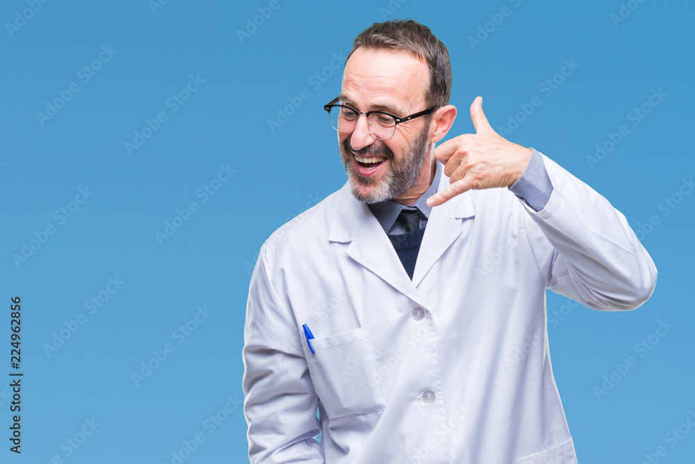 Middle age senior hoary professional man wearing white coat over isolated background smiling doing phone gesture with hand and fingers like talking on the telephone. Communicating concepts. Middle age senior hoary professional man wearing white coat over isolated background smiling doing phone gesture with hand and fingers like talking on the telephone. Communicating concepts.