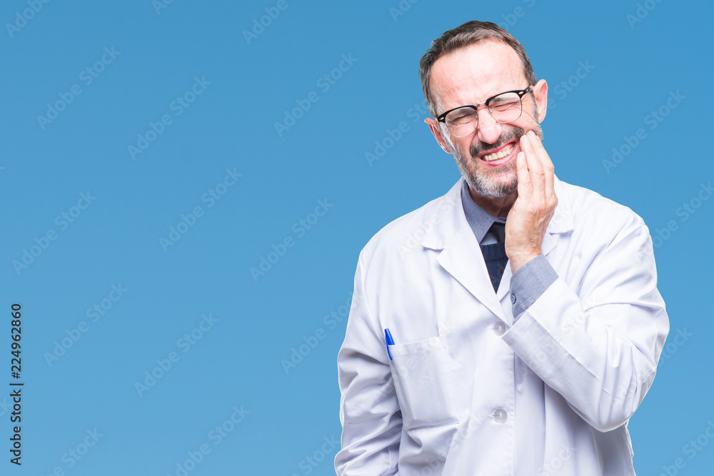 Middle age senior hoary professional man wearing white coat over isolated background touching mouth with hand with painful expression because of toothache or dental illness on teeth. Dentist concept. Middle age senior hoary professional man wearing white coat over isolated background touching mouth with hand with painful expression because of toothache or dental illness on teeth. Dentist concept.
