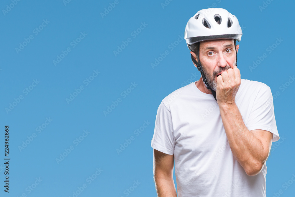 Middle age senior hoary cyclist man wearing bike safety helment isolated background looking stressed and nervous with hands on mouth biting nails. Anxiety problem. Middle age senior hoary cyclist man wearing bike safety helment isolated background looking stressed and nervous with hands on mouth biting nails. Anxiety problem.