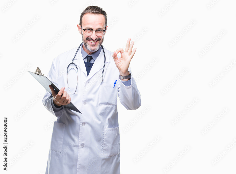 Middle age senior hoary doctor man holding clipboard over isolated background doing ok sign with fingers, excellent symbol Middle age senior hoary doctor man holding clipboard over isolated background doing ok sign with fingers, excellent symbol