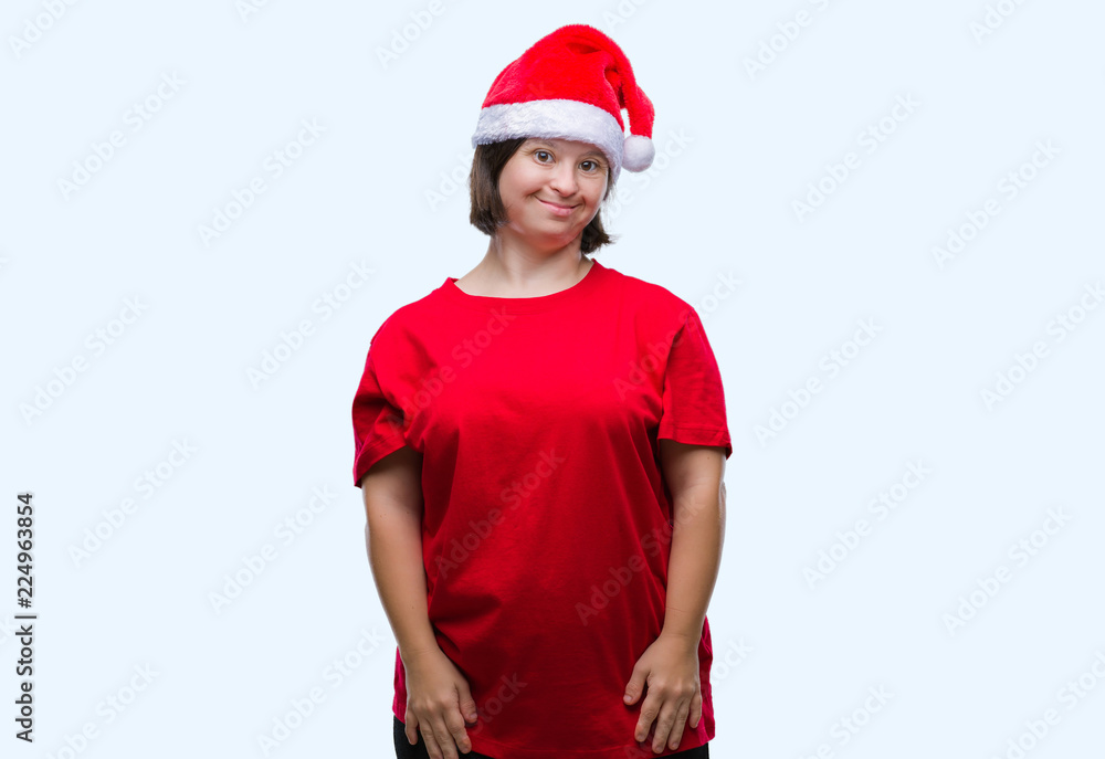 Young adult woman with down syndrome wearing christmas hat over isolated background with a happy and cool smile on face. Lucky person.