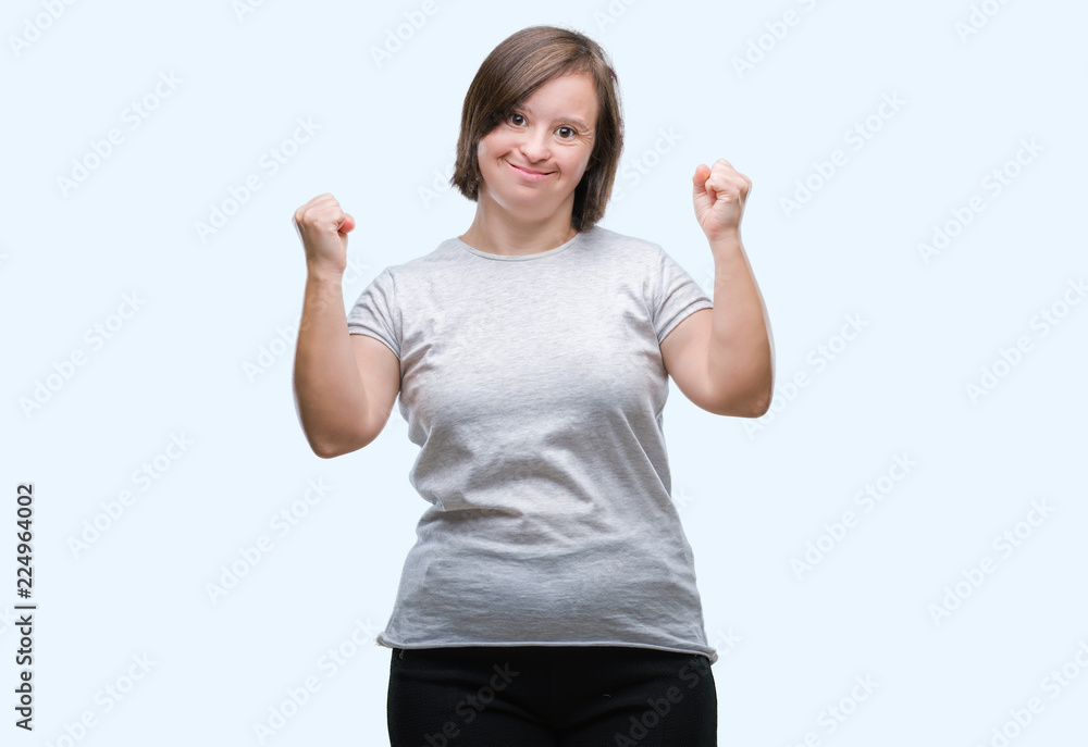 Young adult woman with down syndrome over isolated background very happy and excited doing winner gesture with arms raised, smiling and screaming for success. Celebration concept. Young adult woman with down syndrome over isolated background very happy and excited doing winner gesture with arms raised, smiling and screaming for success. Celebration concept.