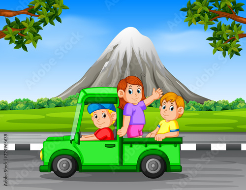 the happy family waving inside the car with the beautiful rock mountain background 
