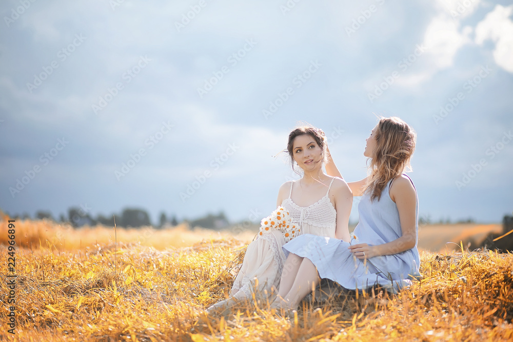 Two girls in dresses in autumn field Two girls in dresses in autumn field