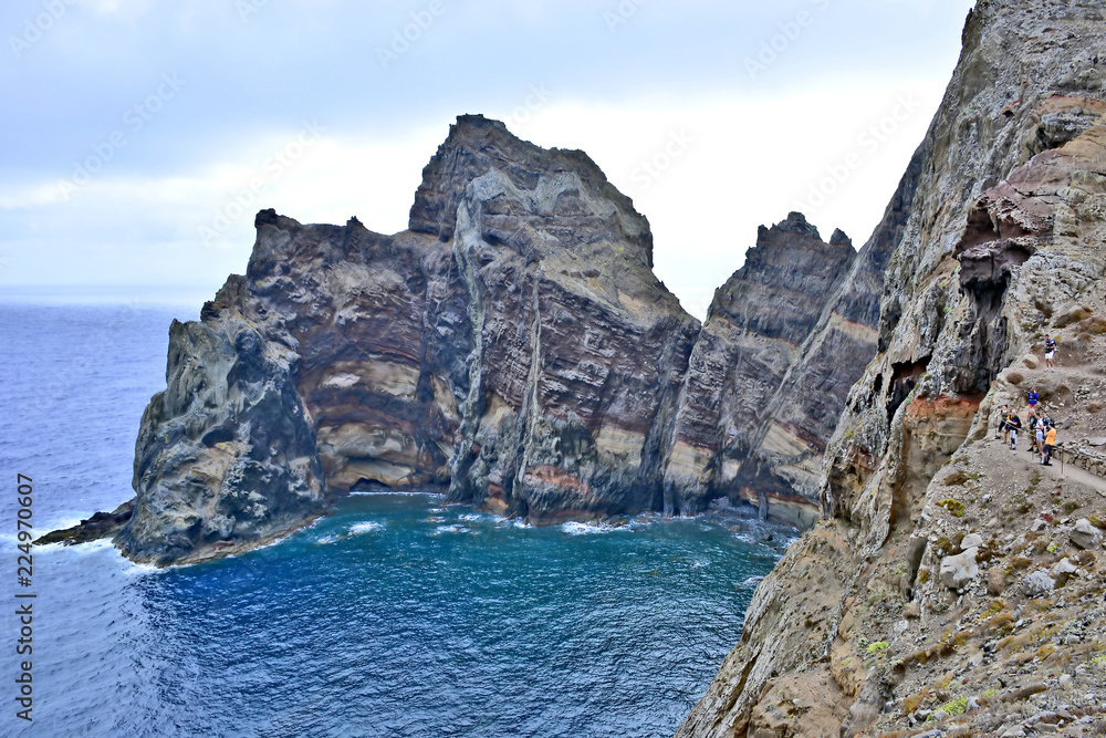Naklejka premium High cliffs with rocks in ocean on coast of Madeira island at Ponta de Sao Lourenco, Portugal
