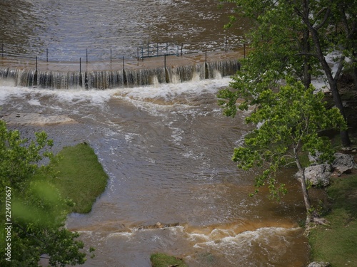 Overflowing muddy water in a waterfalls following heavy rains photo