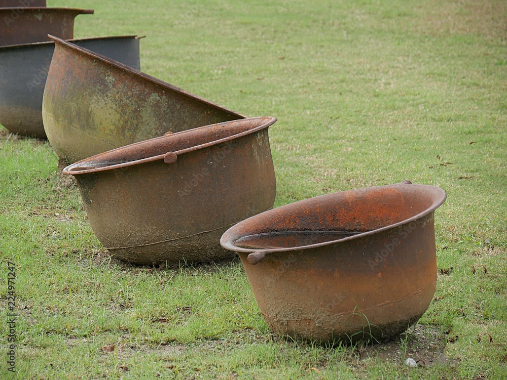 Vintage sugar kettles used in the 19th century plantations to cook