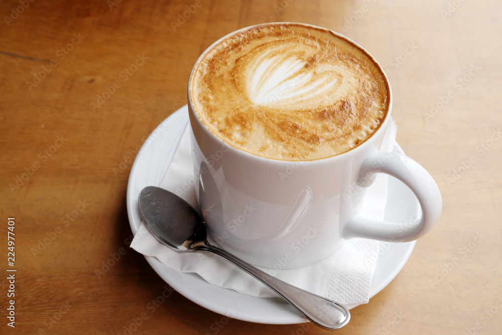 Hot latte on a wooden table Hot latte on a wooden table