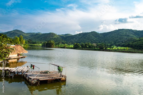 The wooden bridge in the reservoir The background of mountains and trees