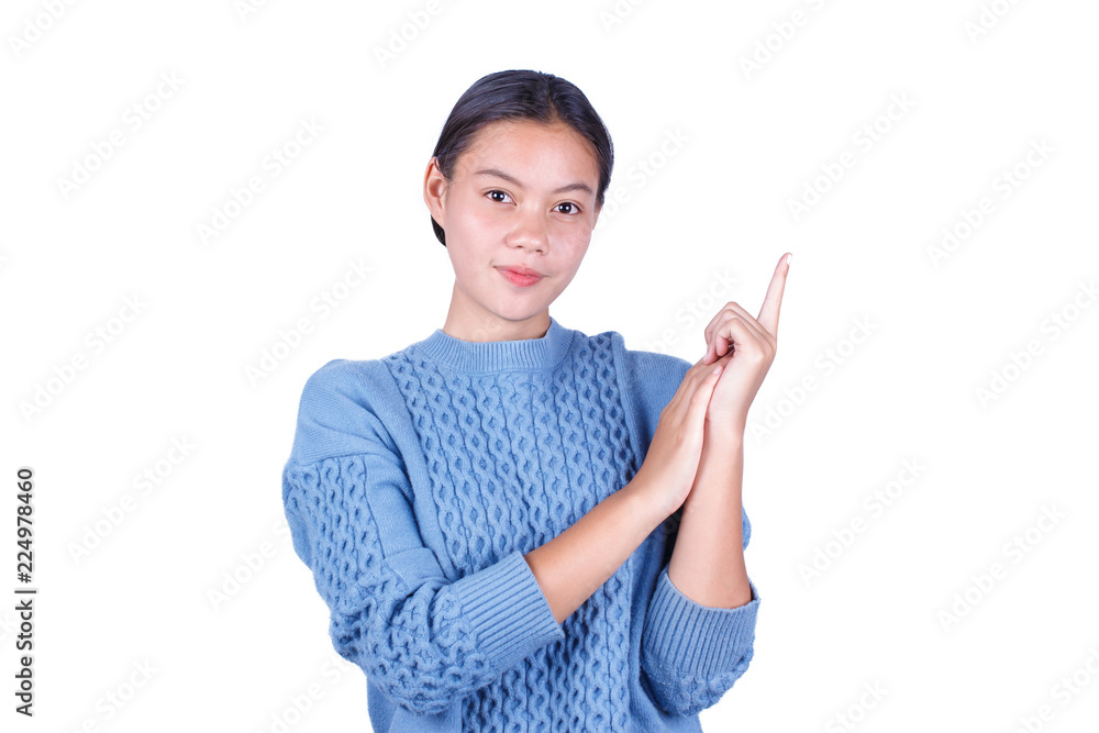 Cute Asian young girl is standing and pointing her finger up isolated on white background Cute Asian young girl is standing and pointing her finger up isolated on white background