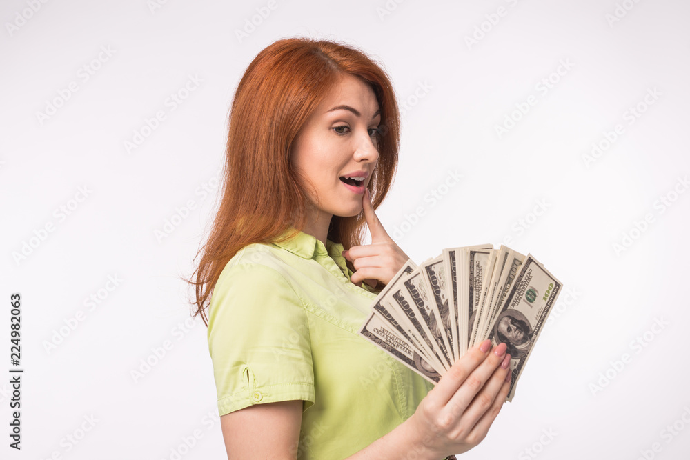 Redhead woman with money on white background Redhead woman with money on white background