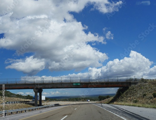 Overpass on a highway in New Mexico, with beautiful cloud formations on a sunny day