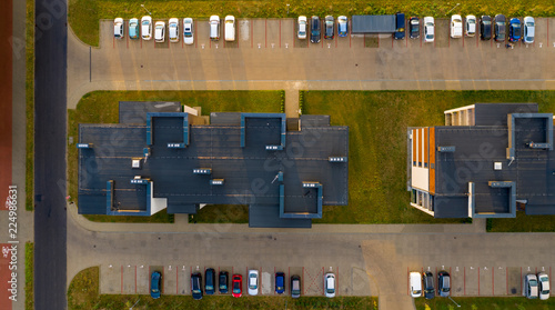 Obraz na płótnie Top down view on multi-family houses and parking with cars. w salonie